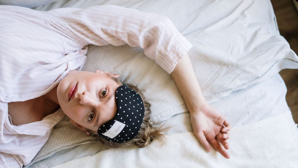 woman in bed with insomnia unable to sleep