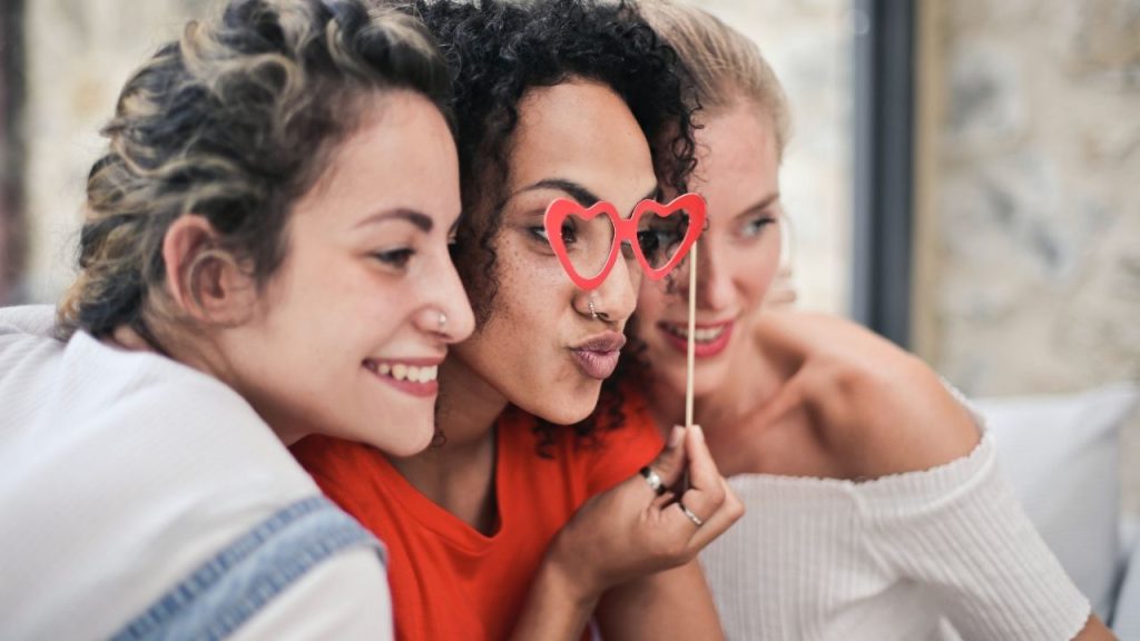 three girlfriends laughing and posing for a picture