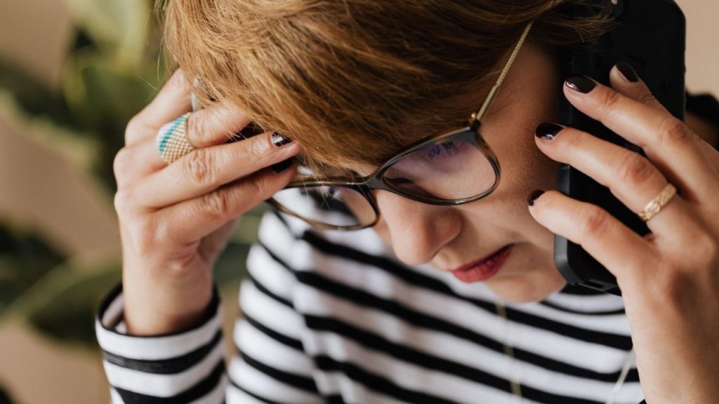 woman in striped shirt on phone