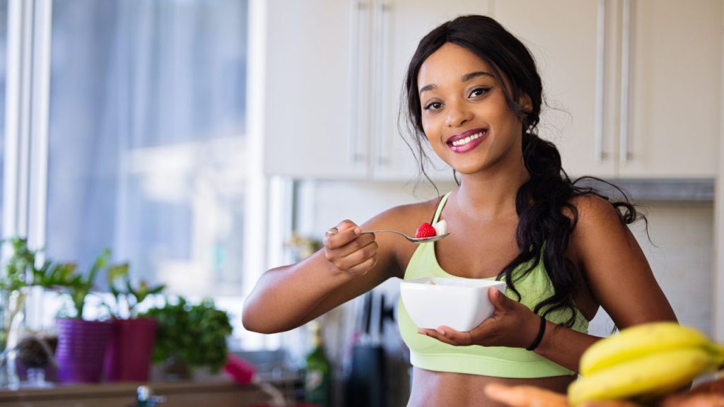 healthy woman eating fruit